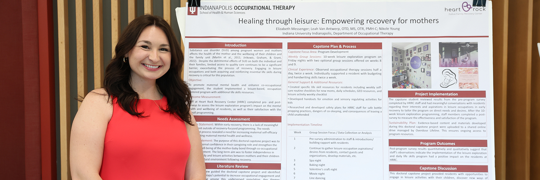 IU Indianapolis occupational therapy student poses by research poster