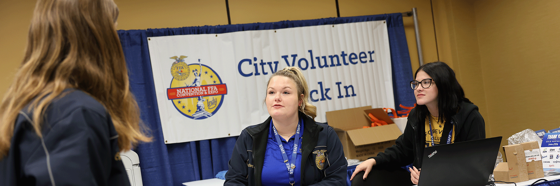 Two TESM students work volunteer check in during the 2024 FFA conference. 